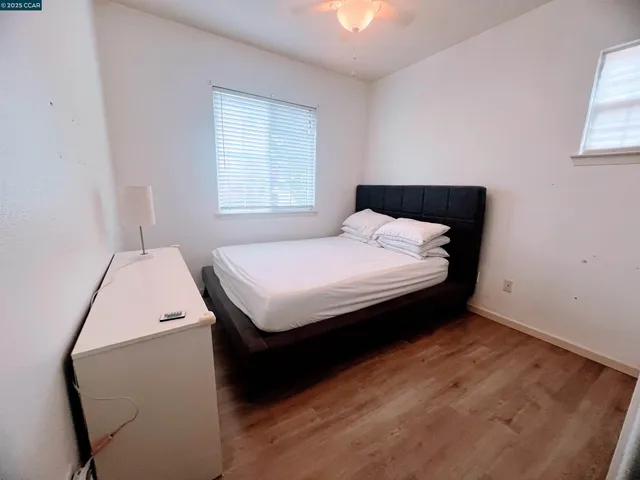 a view of an empty room with toys and a ceiling fan