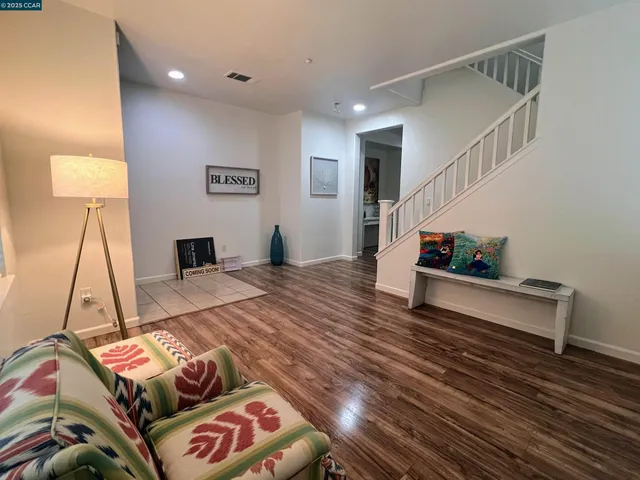 a bedroom with furniture and a wooden floor
