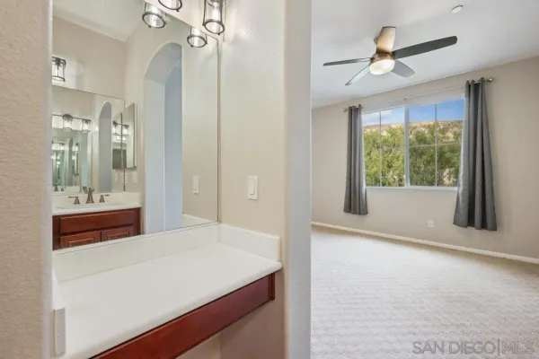 a room with a bed and a large window