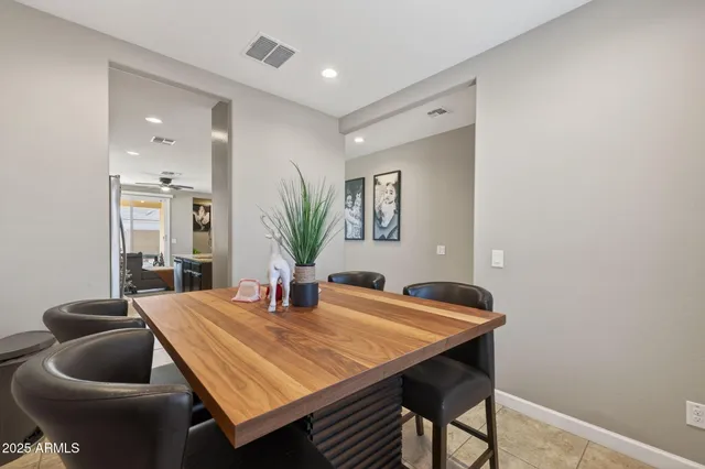 a dining room with furniture and wooden floor