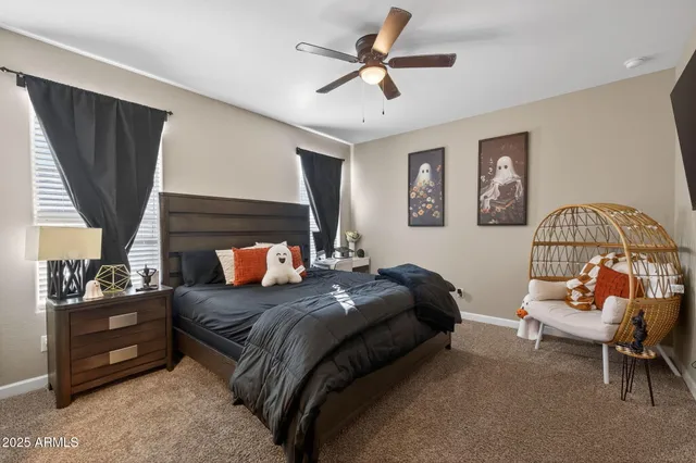 a bedroom with a bed a couch and a window