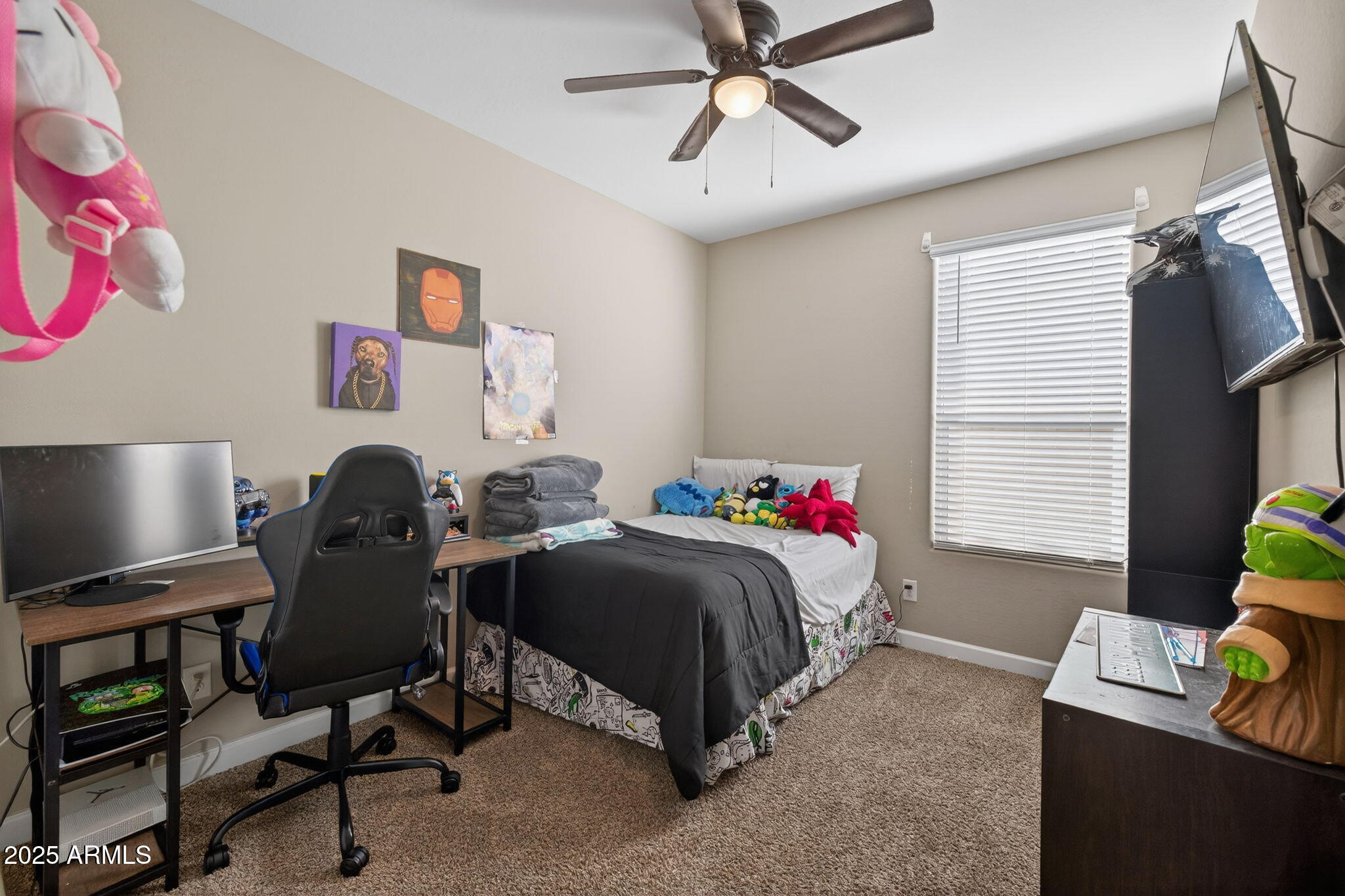8269 West Rushmore Way Florence, AZ 85132 - Photo 16 of 27 a bedroom with a bed and a chandelier