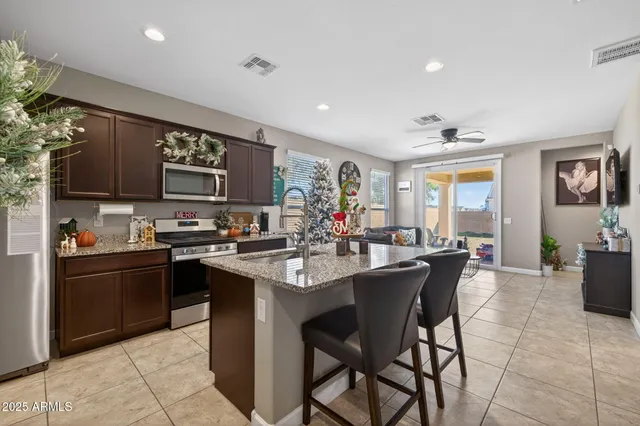 a kitchen with stainless steel appliances kitchen island granite countertop a sink and cabinets