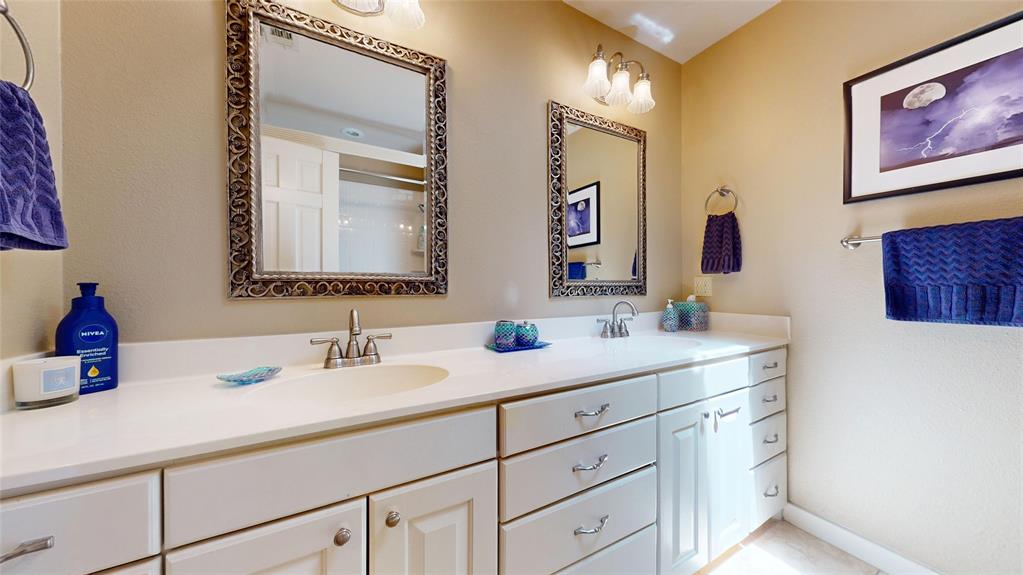 7451 County Road 1509 Athens, TX 75751 - Photo 18 of 36 a bathroom with a double vanity sink and a mirror