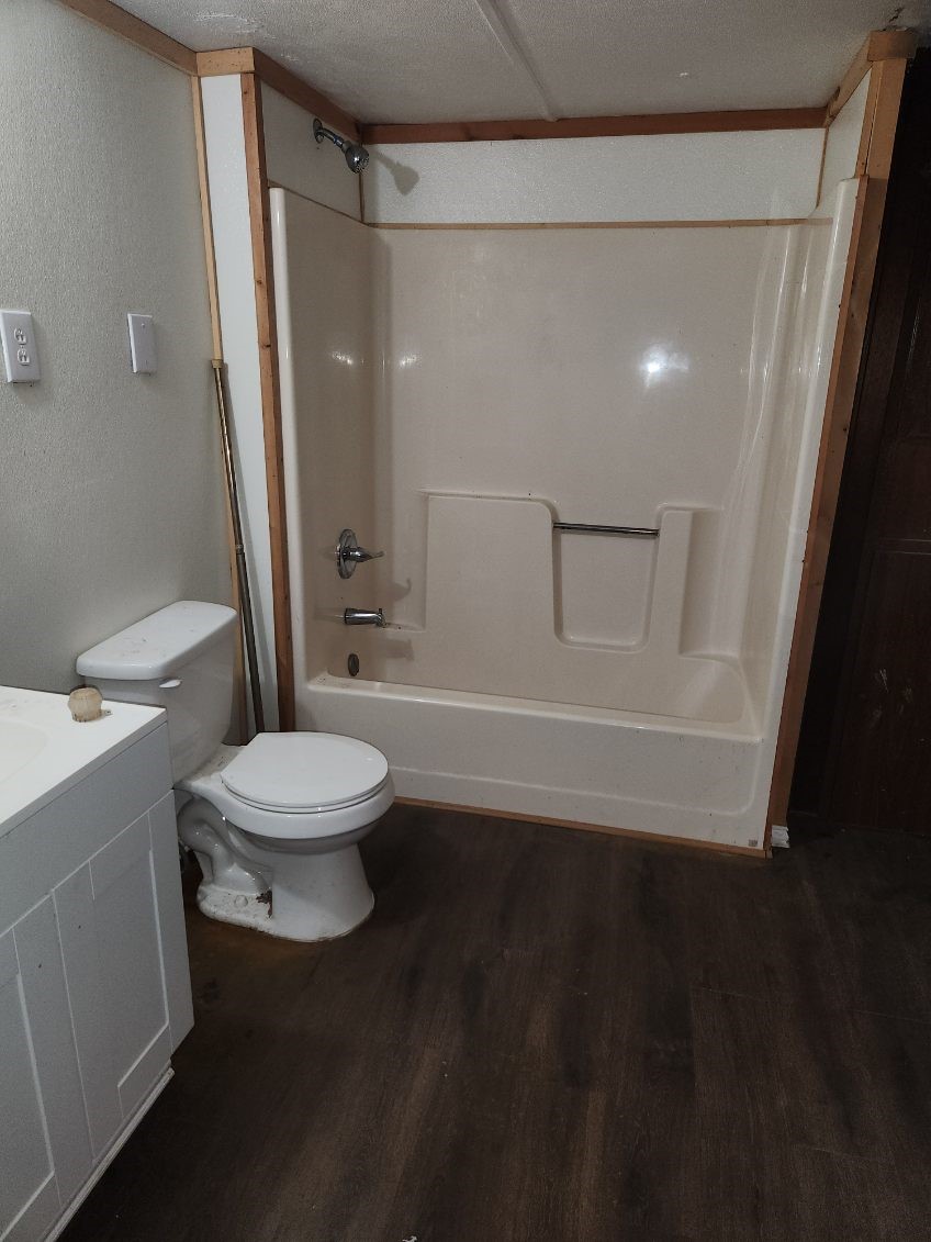 412 Cottonwood Church Road, Unit 7 Rosenberg, TX 77471 - Photo 9 of 10 a bathroom with a toilet a sink and shower