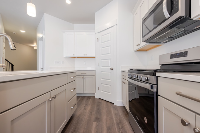 5287 South Acacia Drive, Unit 714 Mapleton, UT 84664 - Photo 9 of 21 Modern kitchen featuring stainless steel appliances, light-toned cabinetry, and wood-finish flooring