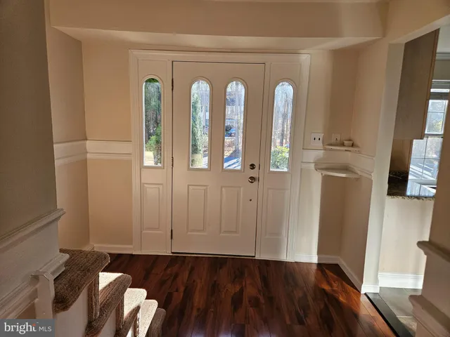 a kitchen with granite countertop a stove a sink and a microwave