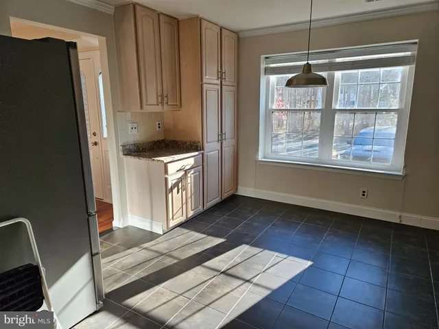a kitchen with stainless steel appliances a refrigerator and a stove top oven