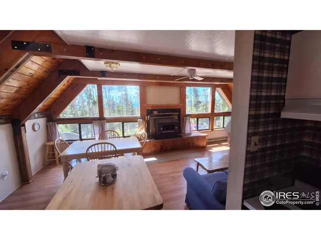 a living room with furniture a window and a fireplace