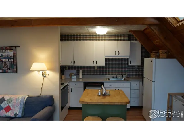 a kitchen with stainless steel appliances kitchen island granite countertop a sink and cabinets