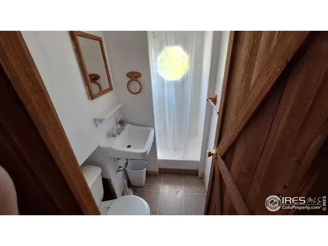 a balcony with furniture and wooden floor