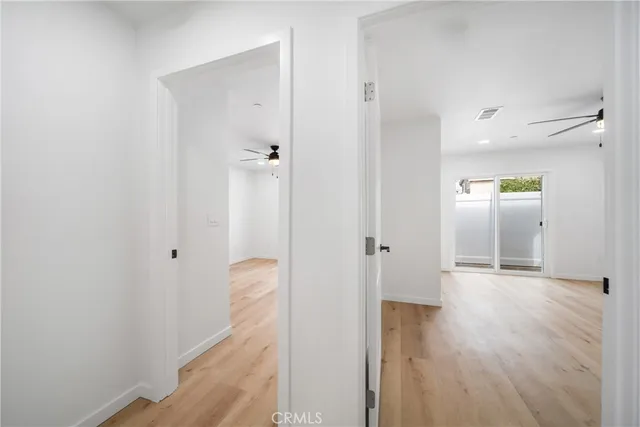 a view of hallway with wooden floor