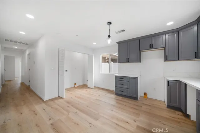 a view of kitchen with wooden floor and electronic appliances