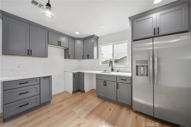 a kitchen with a refrigerator and a sink
