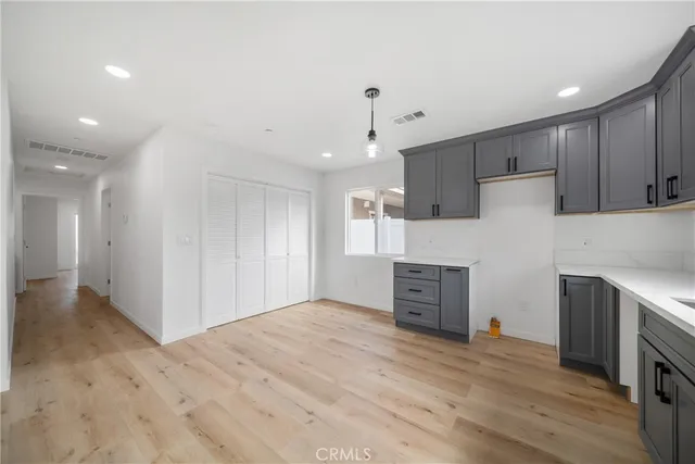 a view of kitchen with wooden floor and electronic appliances