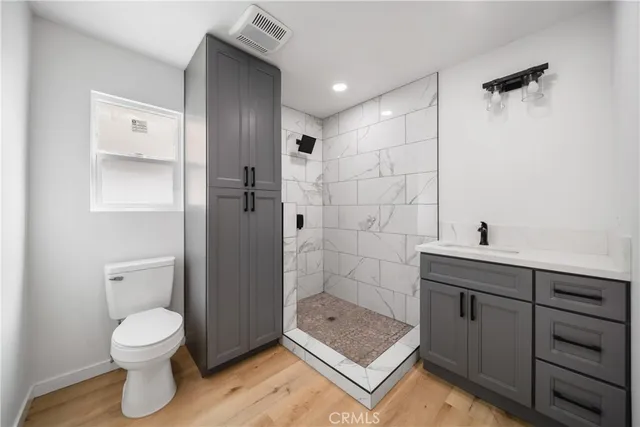 a bathroom with a toilet a sink and shower