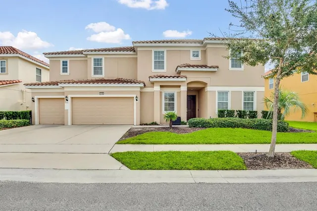 a front view of a house with a yard and garage