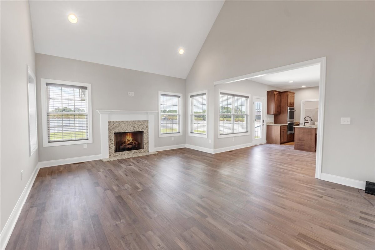 1273 Norton Road Manchester, TN 37355 - Photo 8 of 53 an empty room with wooden floor and fireplace