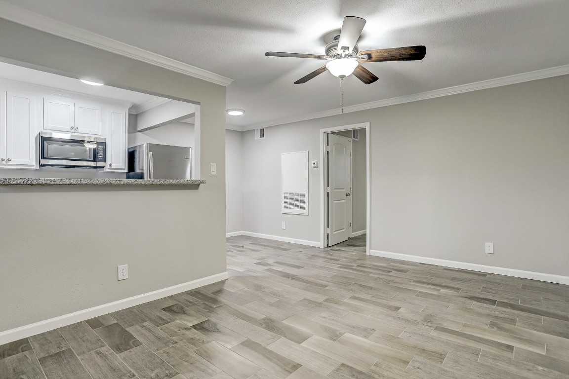 405 Hawthorne Street, Unit 22 Houston, TX 77006 - Photo 3 of 10 a view of a kitchen with a sink and a chandelier fan