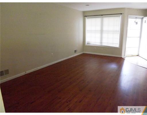 18 Lakeview Drive Helmetta, NJ 08828 - Photo 5 of 11 an empty room with wooden floor and windows