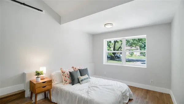 a bedroom with a bed and a window