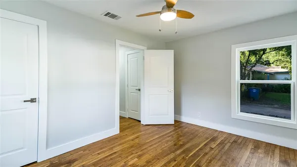 wooden floor in an empty room with a window