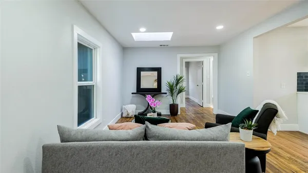 a living room with furniture and a potted plant