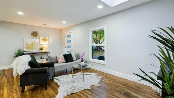 a living room with furniture and a potted plant