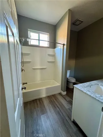 a bathroom with a tub toilet and a sink