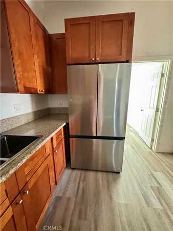 a kitchen with a refrigerator and a sink