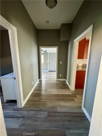 a view of a hallway view with wooden floor and staircase