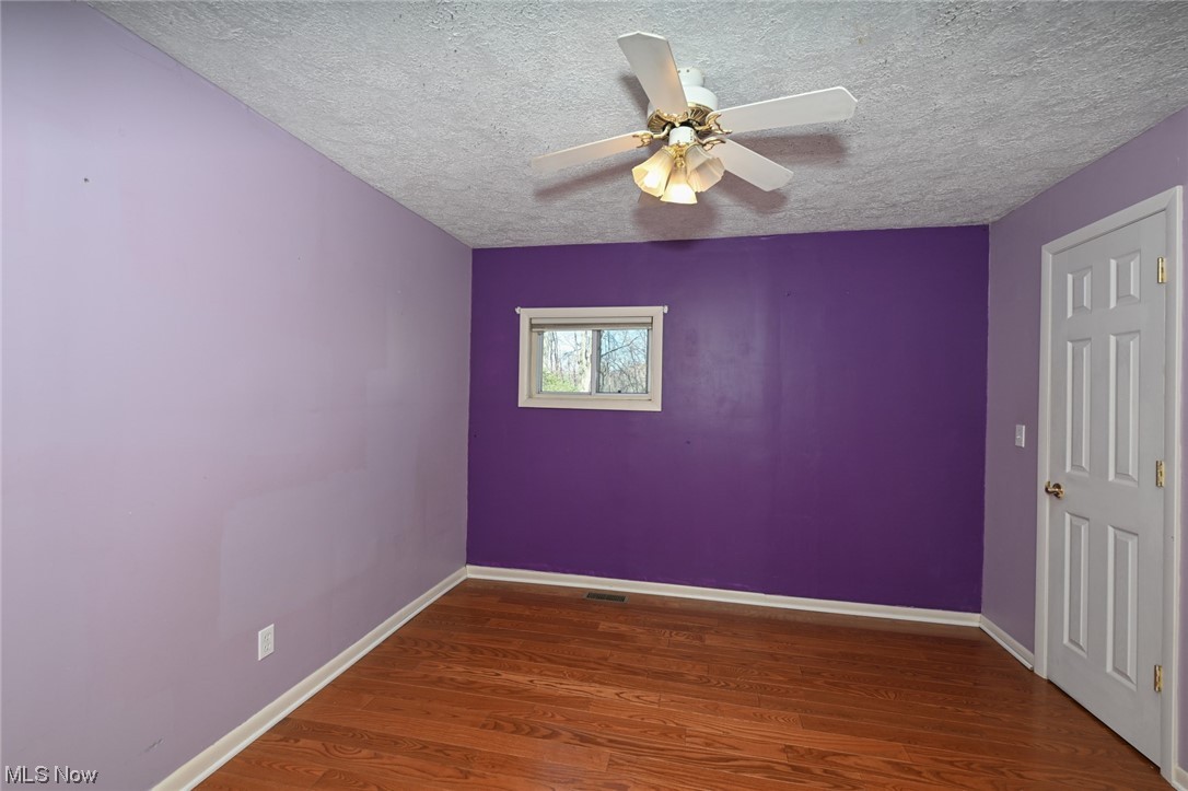 1509 McTaggart Road Stow, OH 44224 - Photo 24 of 30 Second Bedroom with ceiling fan, dark hardwood / wood-style floors, and a textured ceiling