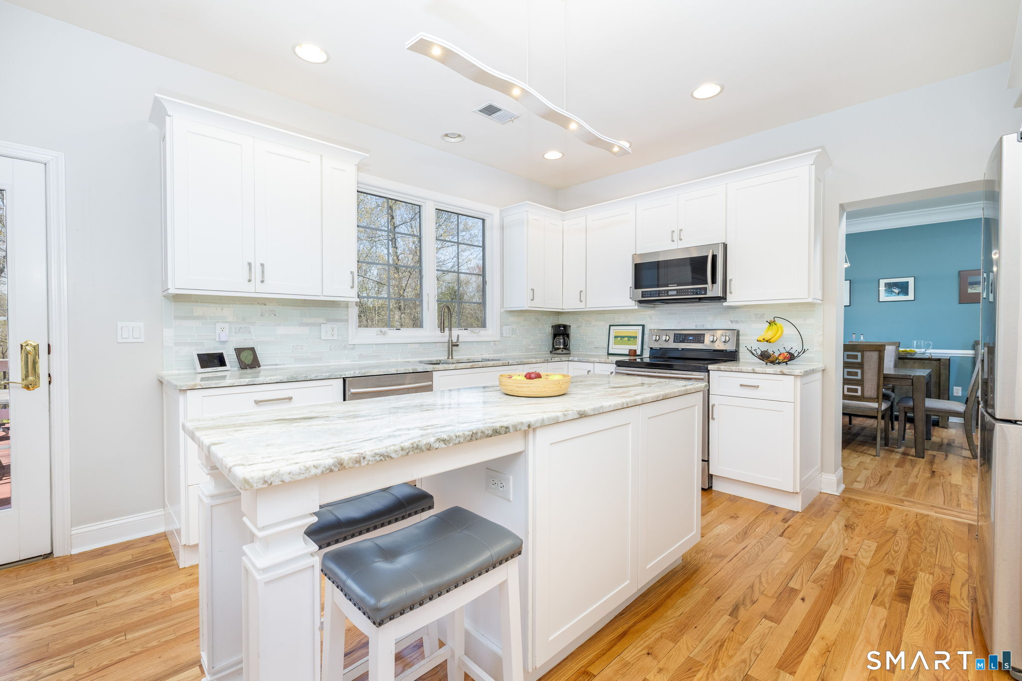 10 Eastham Bridge Road East Hampton, CT 06424 - Photo 12 of 37 A timeless remodel refreshed this kitchen with white cabinets, an island, new appliances, and granite counters.