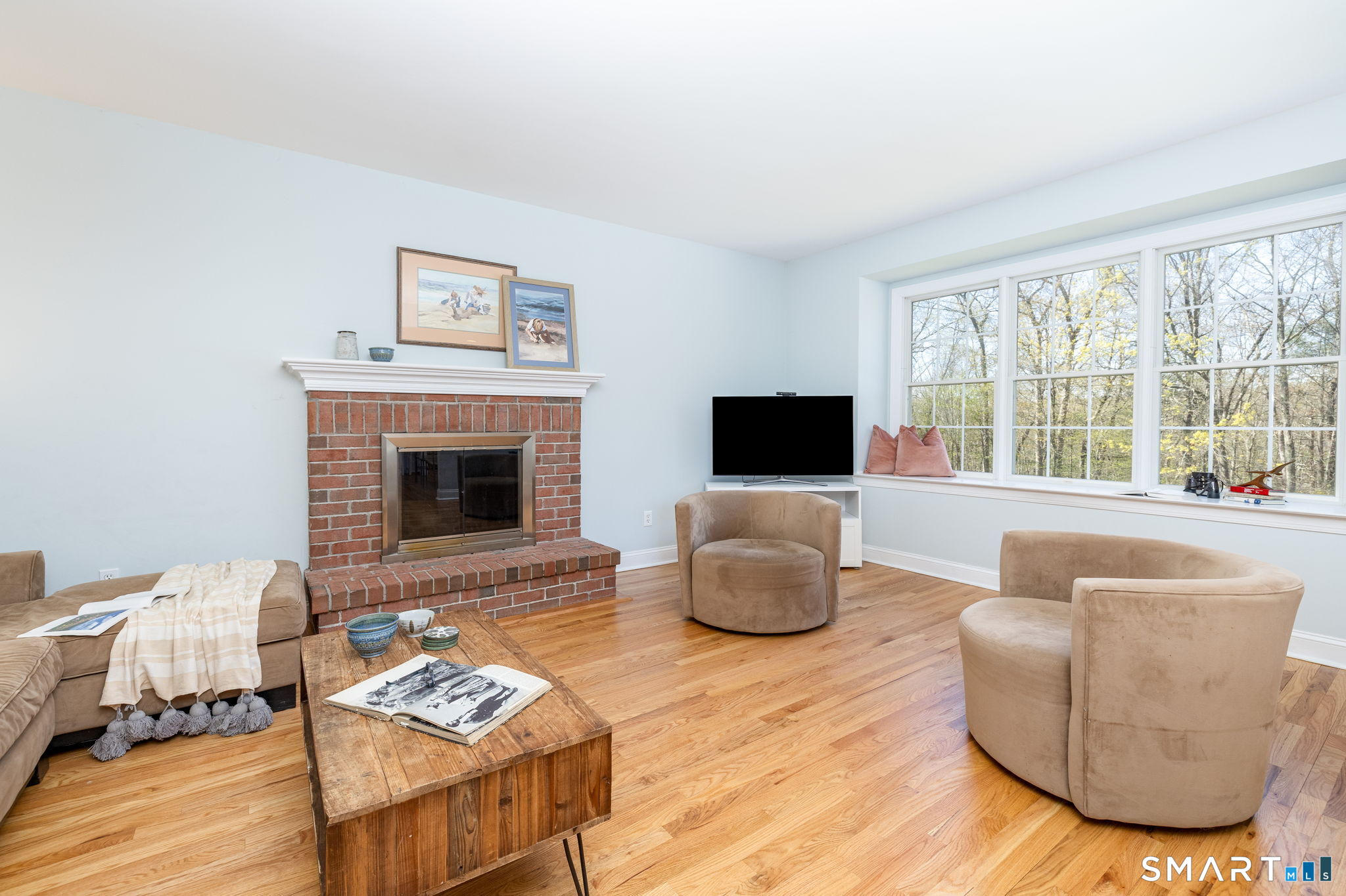 10 Eastham Bridge Road East Hampton, CT 06424 - Photo 18 of 37 This family room is open to the kitchen area, and overlooks the backyard through these gorgeous windows, plus there's a wood-burning fireplace for cozy nights!