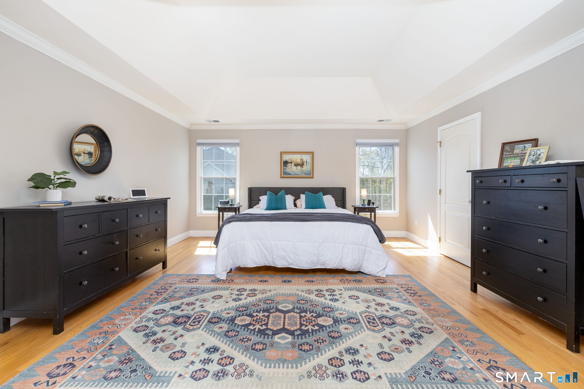 10 Eastham Bridge Road East Hampton, CT 06424 - Photo 23 of 37 Through double doors lies the spacious primary suite, with tray ceiling, seating/office/exercise/flexible space, walk-in closet, and large bathroom with 2 sinks, soaking tub, and shower.