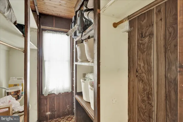 a view of closet with wooden floor
