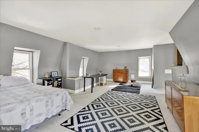 a bedroom with furniture and a window