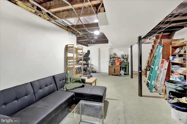 a living room with furniture and a gym