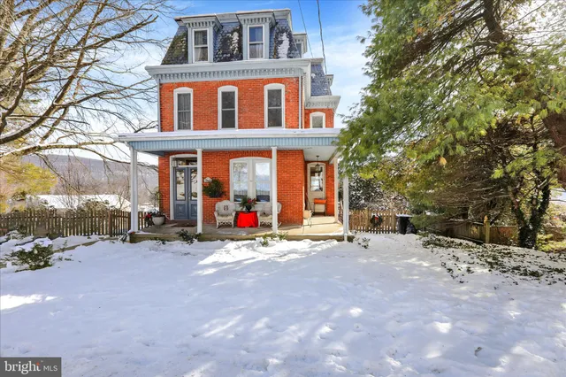 a view of a building with snow on the road