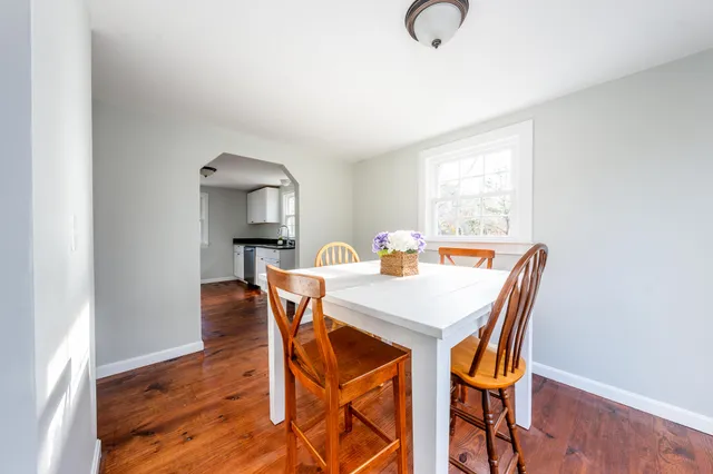 a view of a dining room with furniture and window