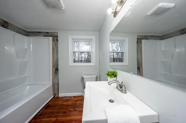 a bath room with a bathtub and a shower