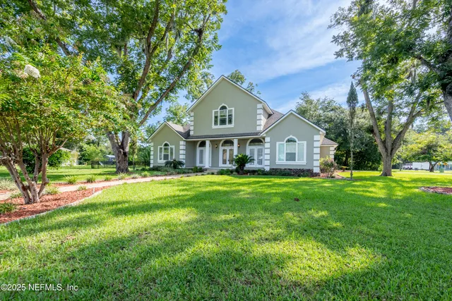 a house view with swimming pool in front of it