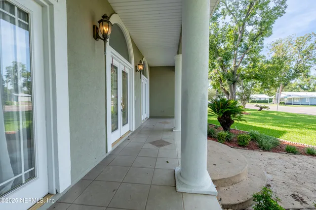 a view of an empty room with a fireplace and a window