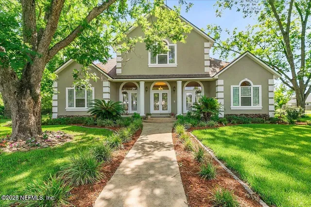 a front view of a house with a garden
