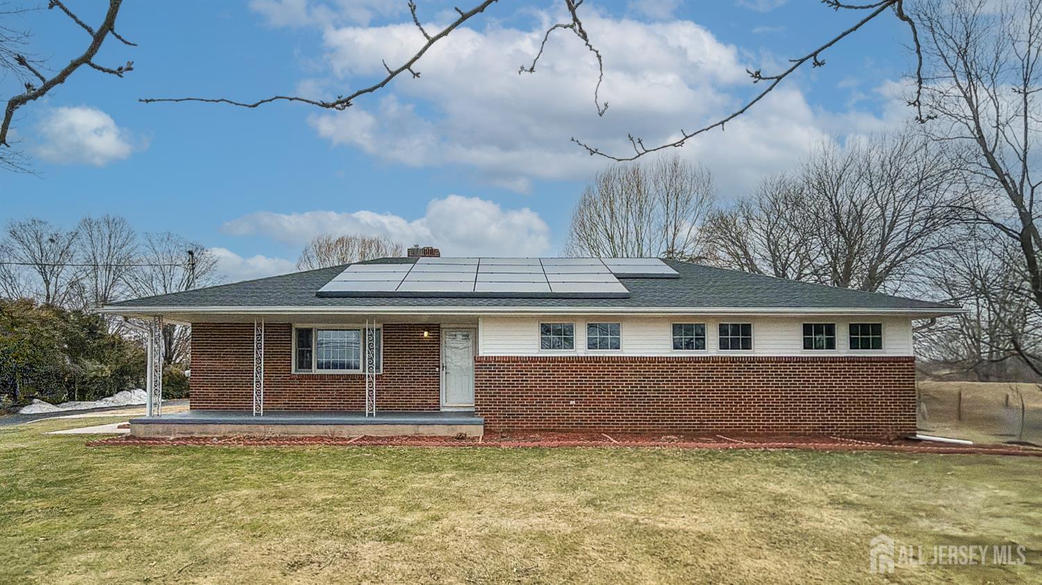 a front view of a house with a garden and yard