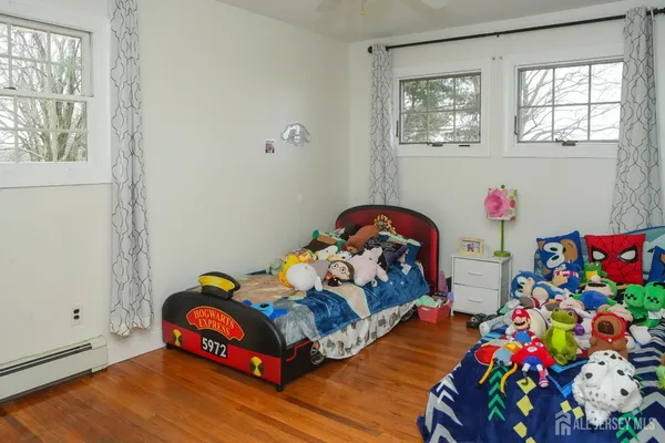 a bed room with two beds and a window