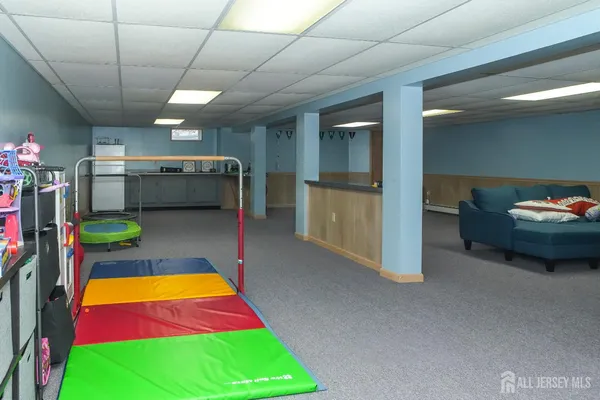 a room with pool table and windows