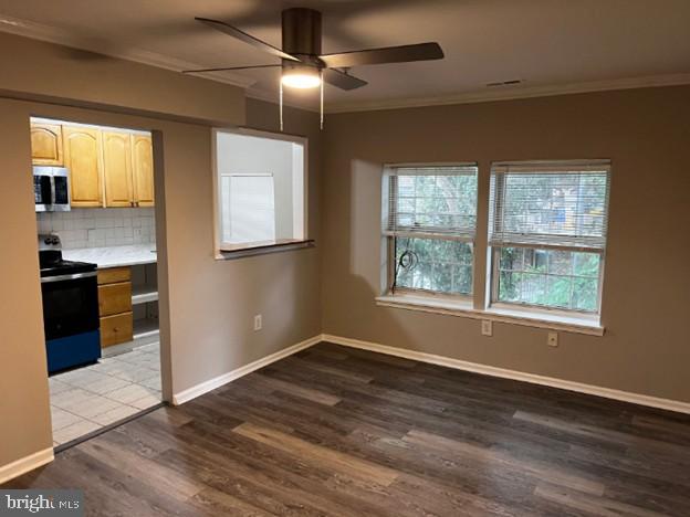 2100 Fendall Street Southeast, Unit 14 Washington, DC 20020 - Photo 2 of 10 an empty room with wooden floor cabinet and windows