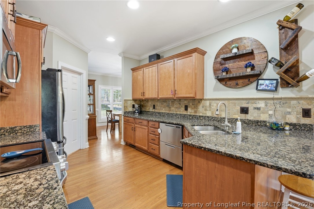 16 Ridge Road Jackson Springs, NC 27281 - Photo 21 of 50 a kitchen with stainless steel appliances granite countertop a refrigerator a stove and a sink
