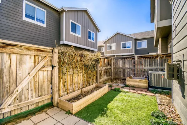 a view of house with backyard and furniture